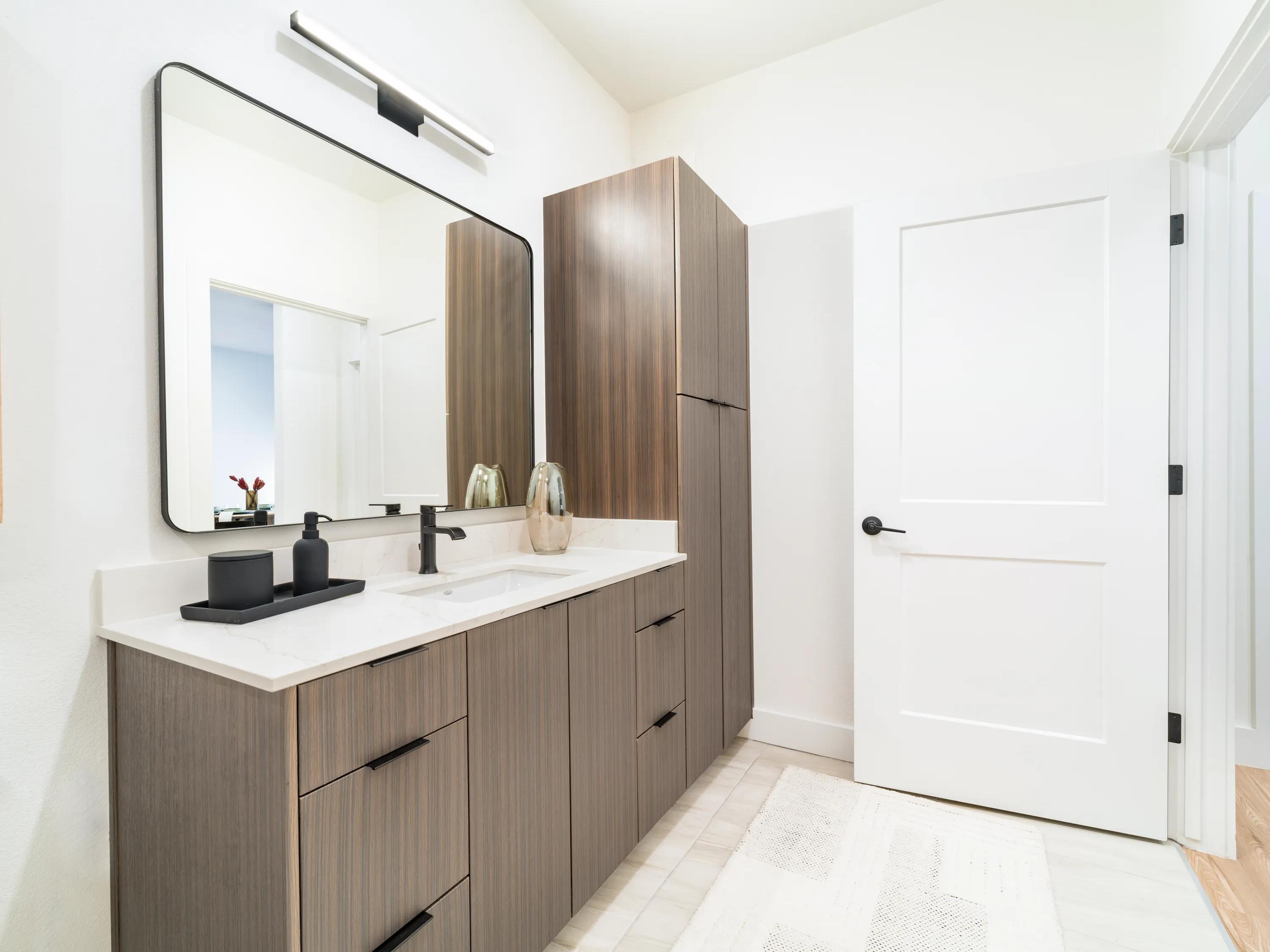 dark cabinetry and white countertops in bathroom modera kierland apartments homes for rent in scottsdale z