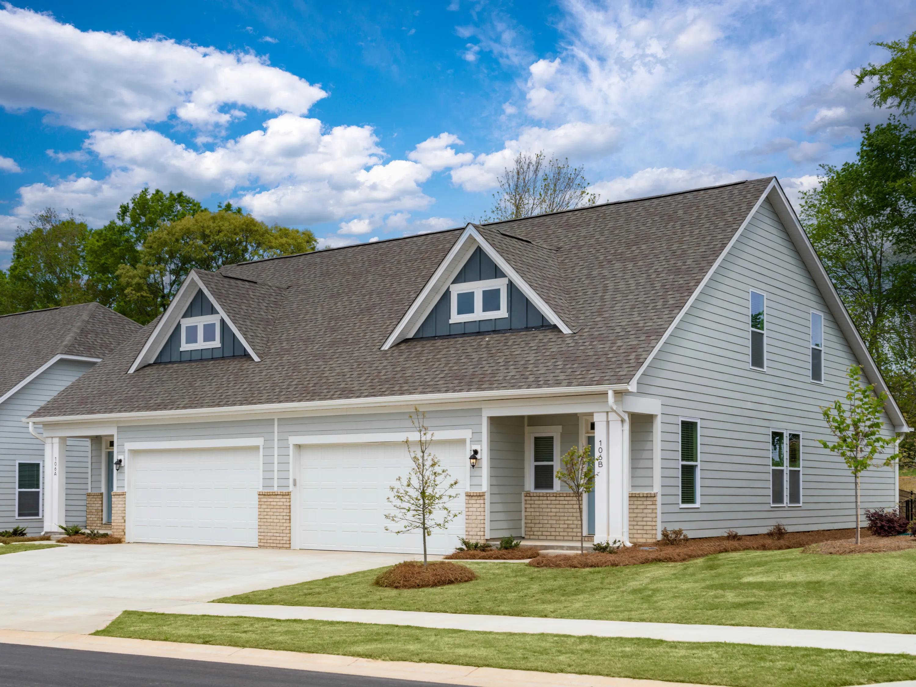 exterior garage and sidewalk of home with lawn amavi mooresville apartment homes for rent in nc