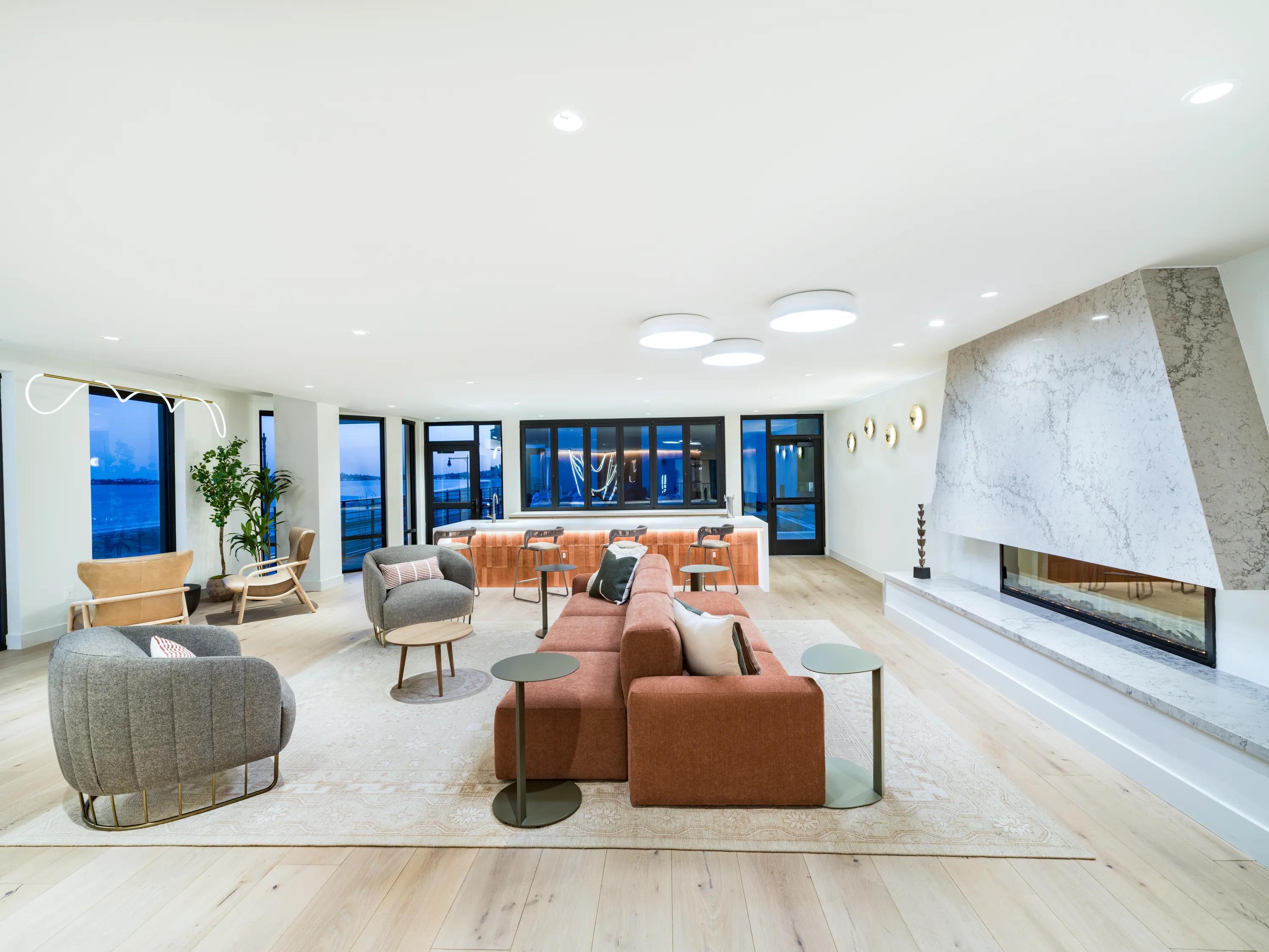 resident lounge with multiple seating areas lounge seating with accent wall modera revere beach apartments for rent in revere ma near boston