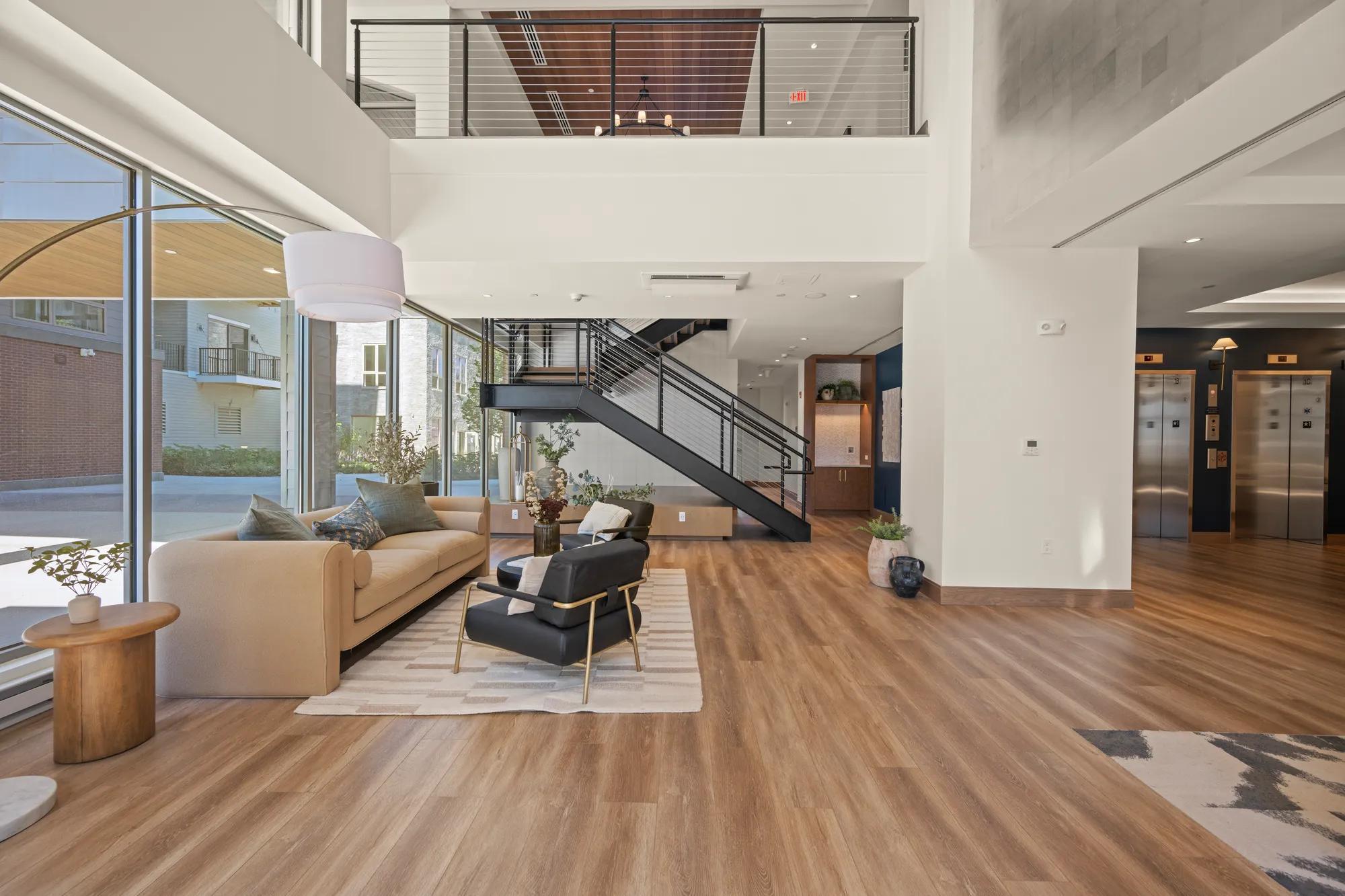 lobby with chic furniture and large windows at modera newton apartment homes for rent in ma
