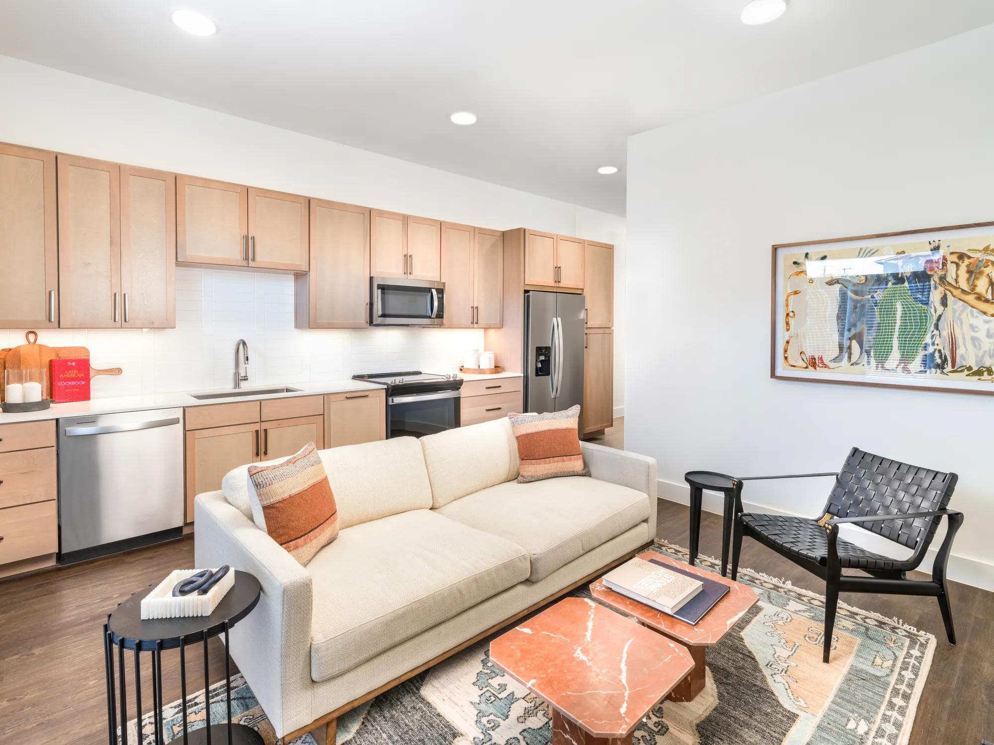couch in open floor plan living room and kitchen modera trailhead apartment homes for rent in dallas texas