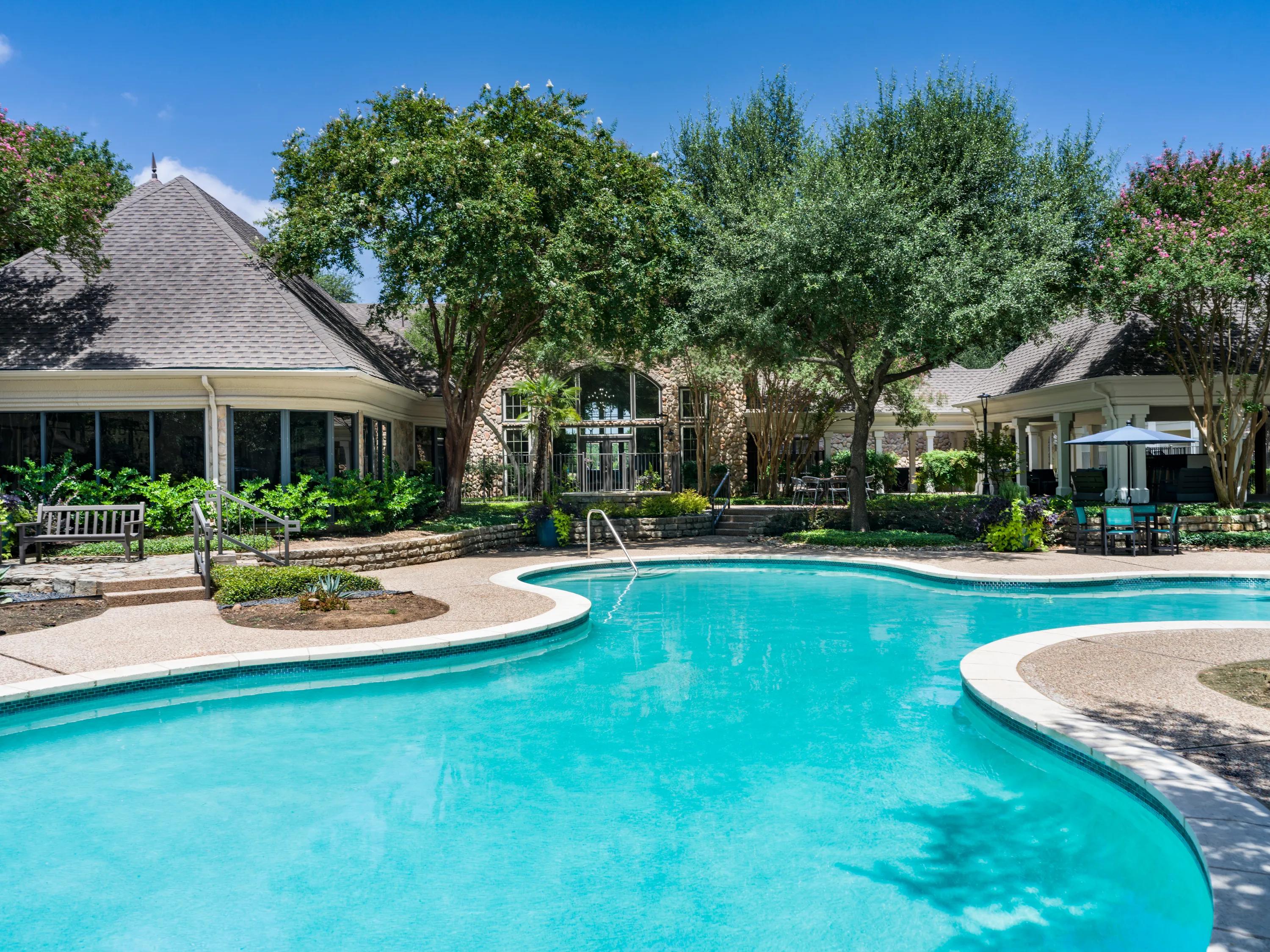 surrounded by mature trees and thoughtful landscaping, the resort-style pool invites quiet moments or casual conversation poolside.
