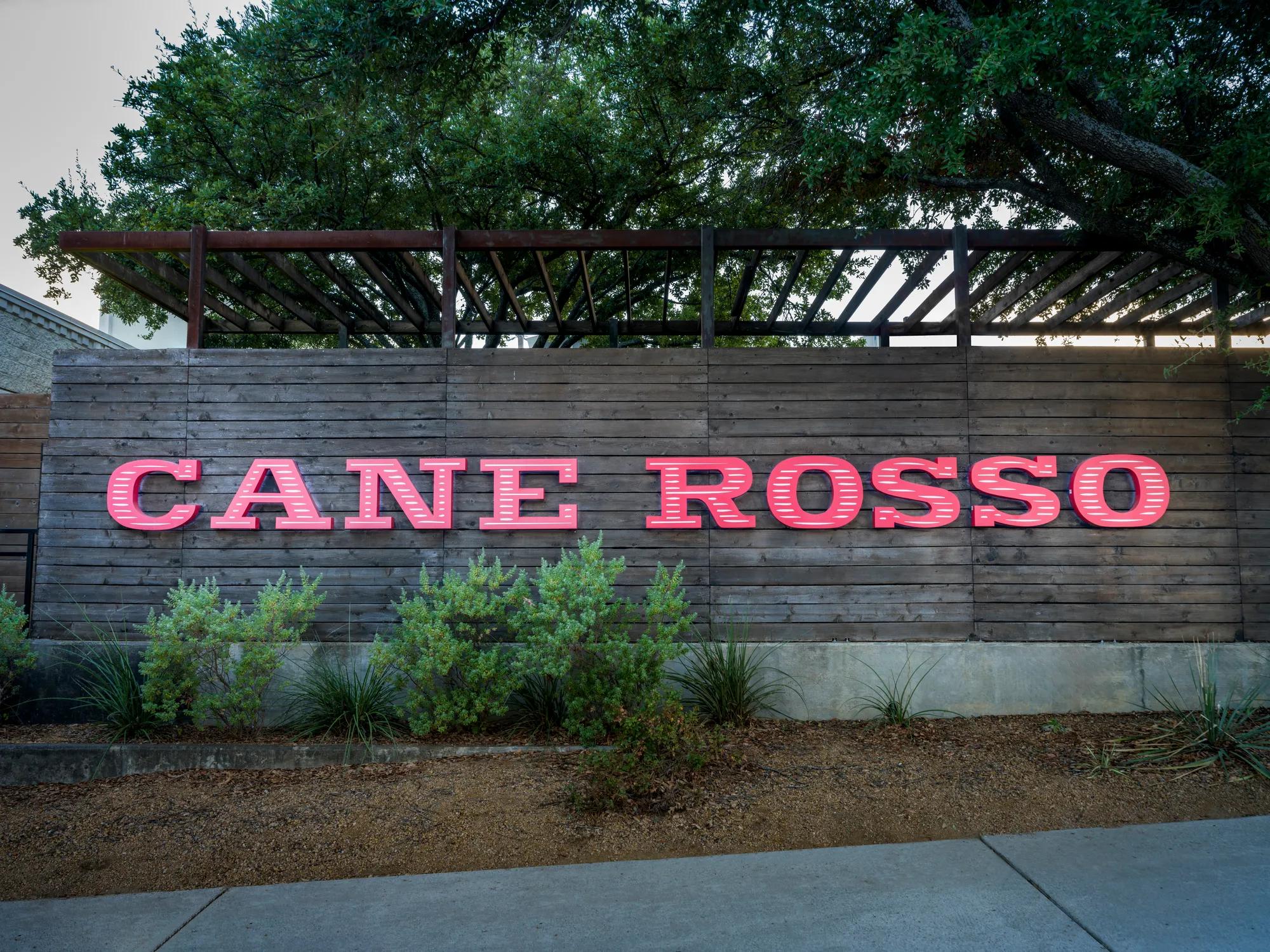 cane rosso logo on fence modera trailhead apartment homes for rent in dallas tx
