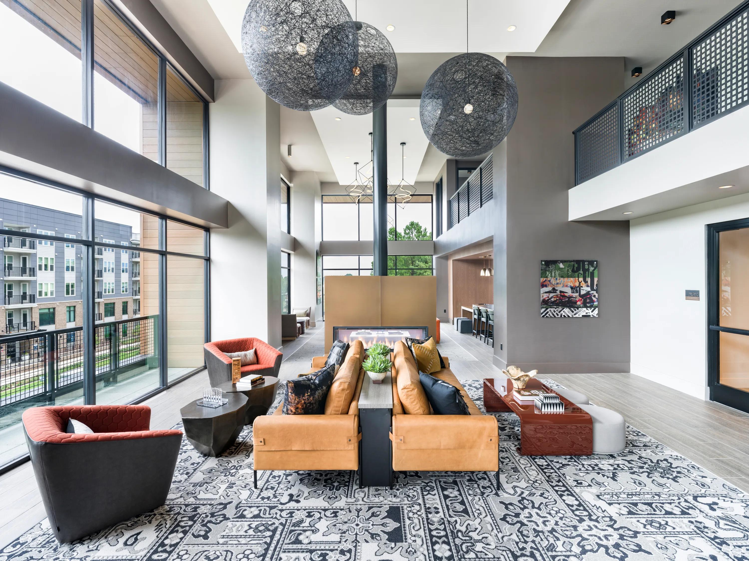 resident lounge with large windows and seating modera loso apartment homes for rent in charlotte nc