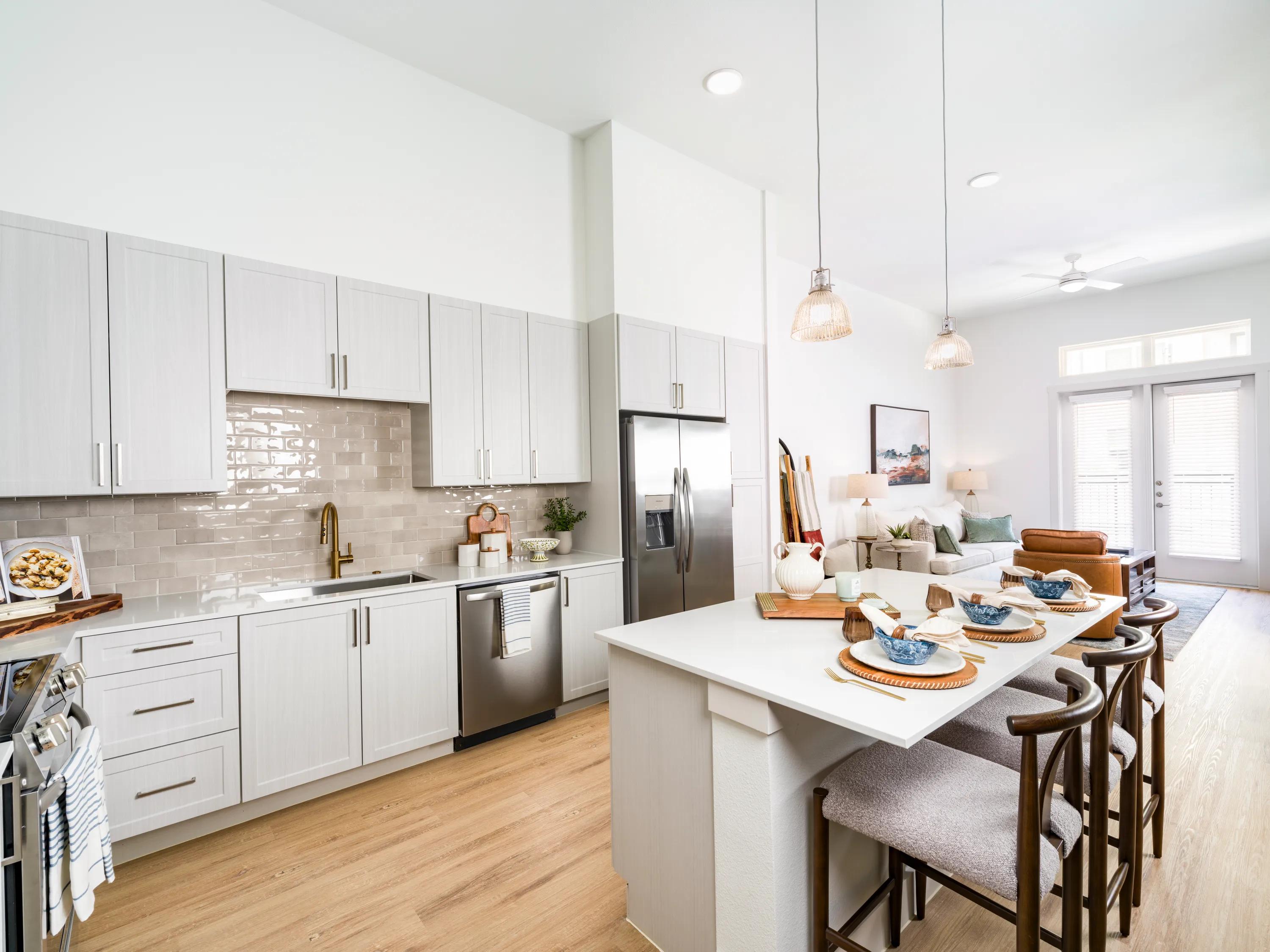 open kitchen with quartz countertops modera walsh heights apartments aledo tx