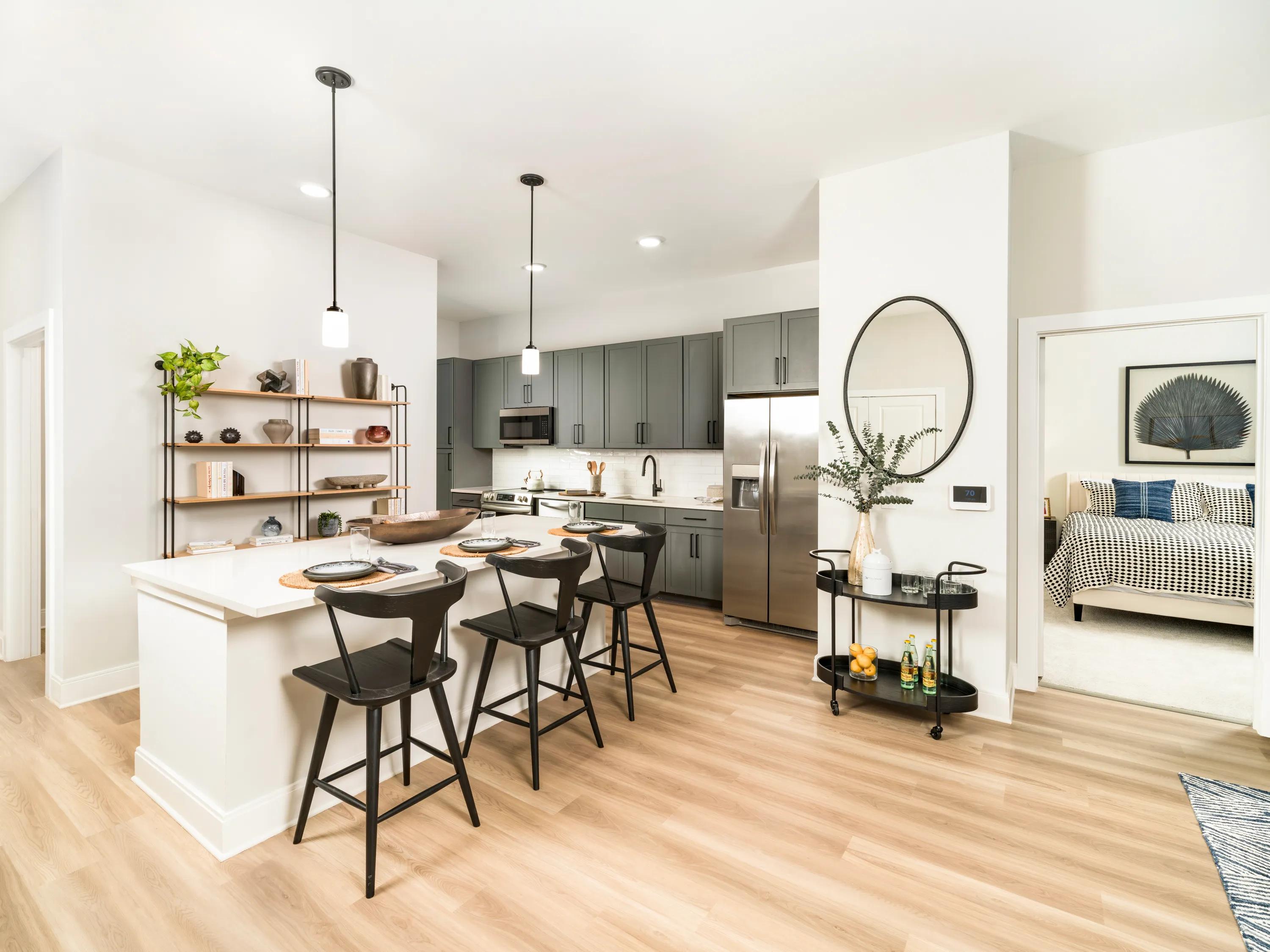 pednant lighting in kitchen with island and white cabinetry modera liberty row apartment homes for rent in in charlotte nc