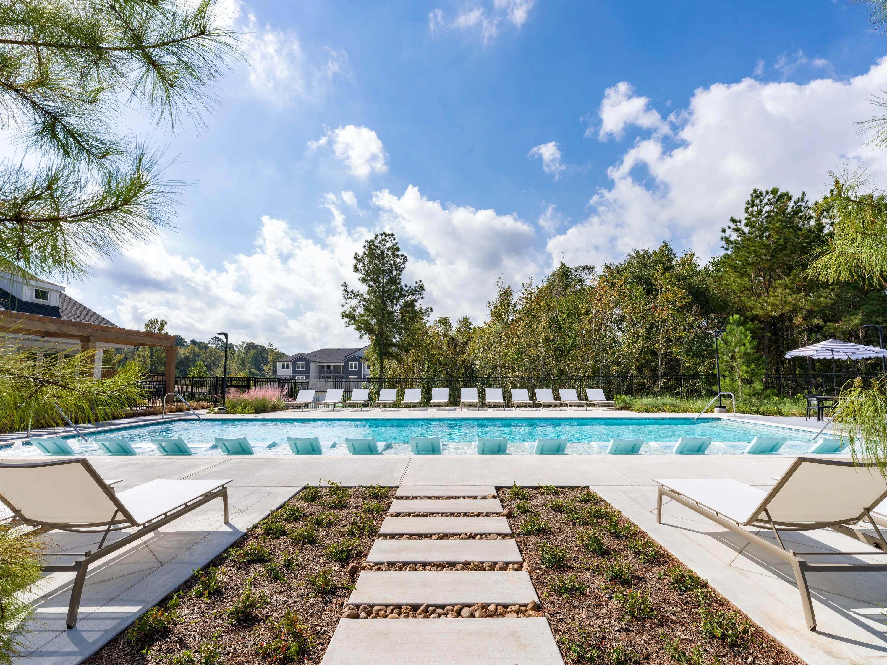 outdoor pool with sundeck loungers beckett west fork apartment homes for rent in conroe tx