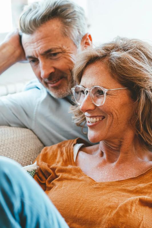 mature couple sitting on couch smiling modera st paul dallas tx apartments