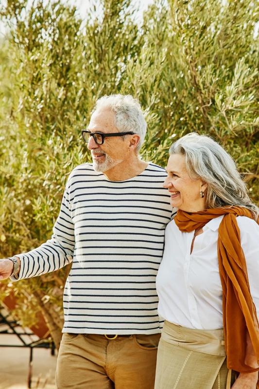 mature couple embracing nearby lake at sunset modera chandler az