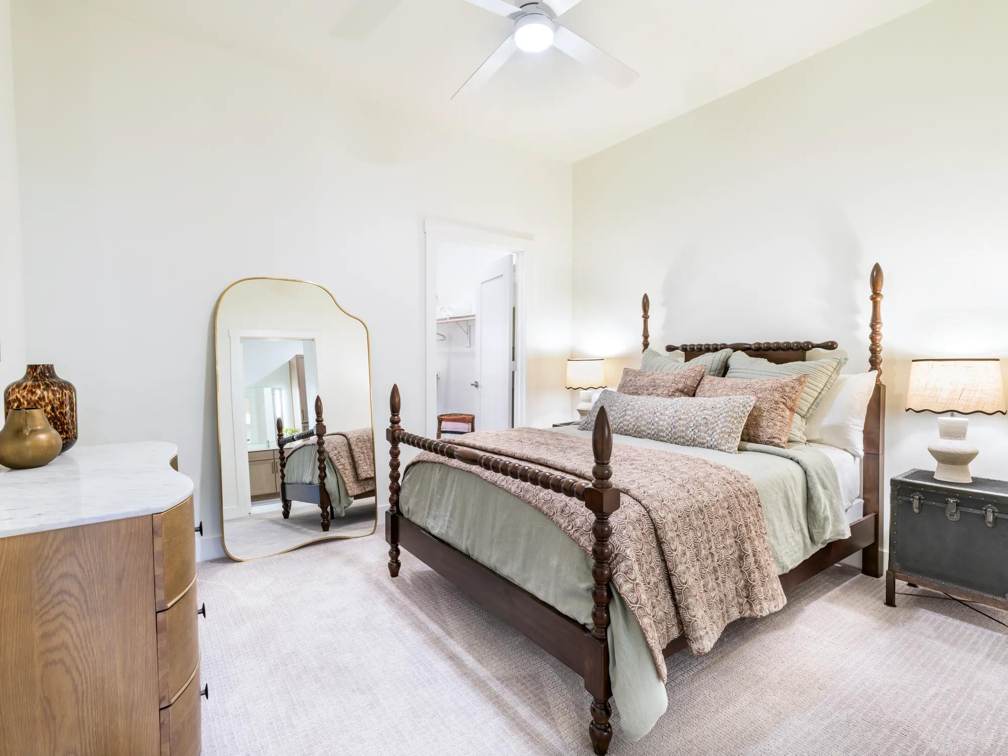 bedroom with bed and mirror with ceiling fan modera trailhead apartment homes for rent in dallas texas